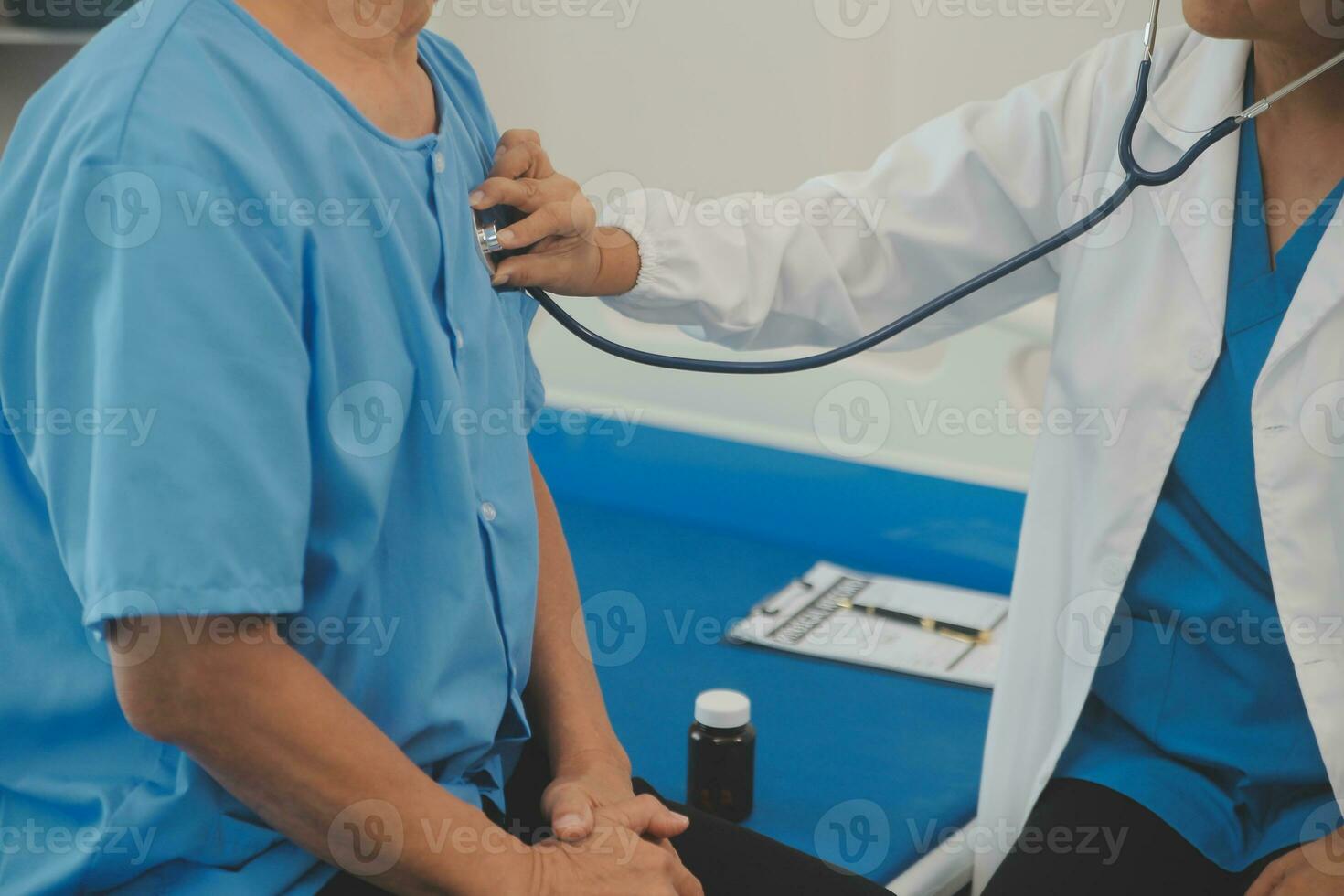 Close up of Female Doctor using stethoscope putting beat heart diagnose with patient in examination room at a hospital, check-up body, Medical and Health Care Concept. photo