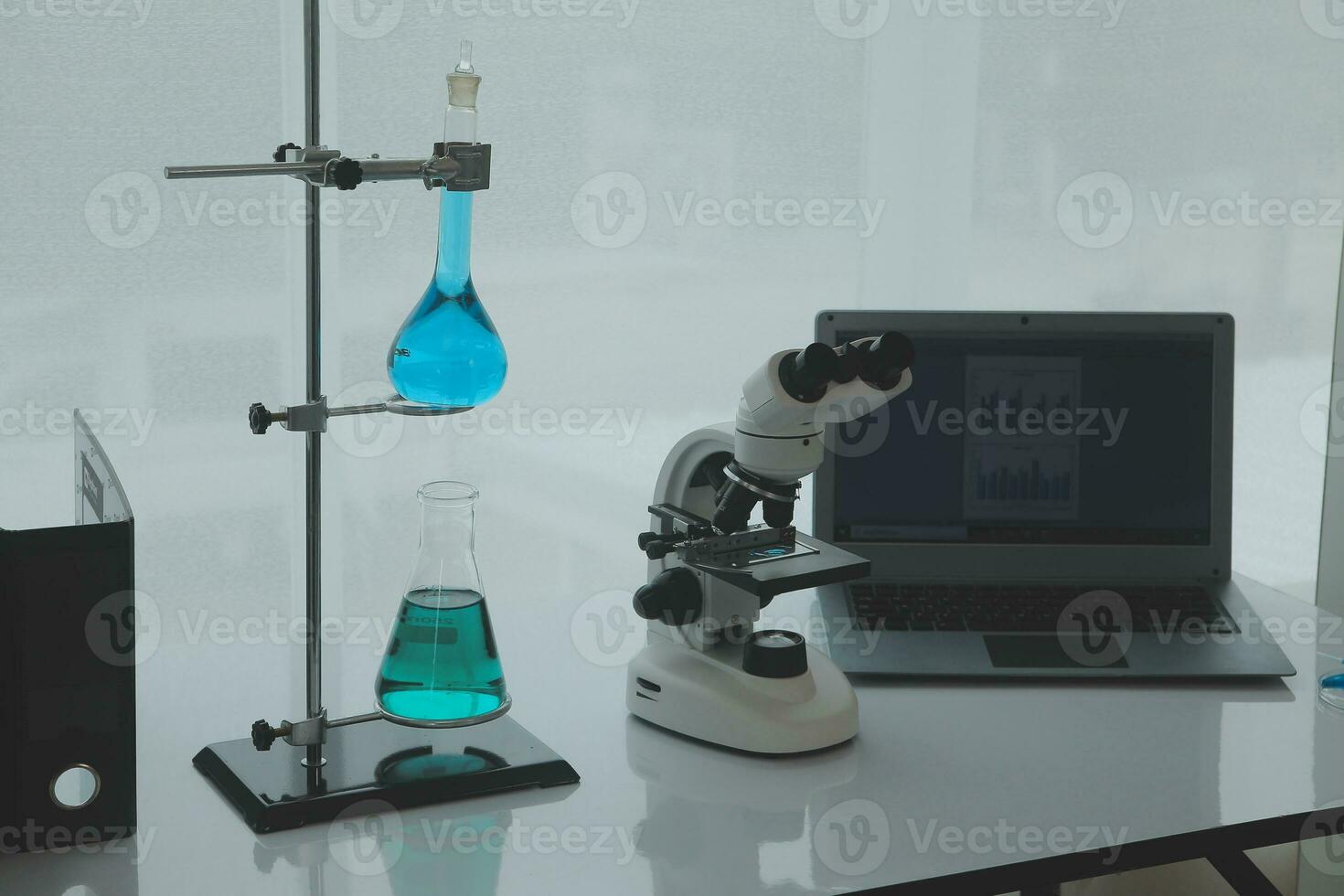 Health care researchers working in life science laboratory. Young female research scientist and senior male supervisor preparing and analyzing microscope slides in research lab. photo