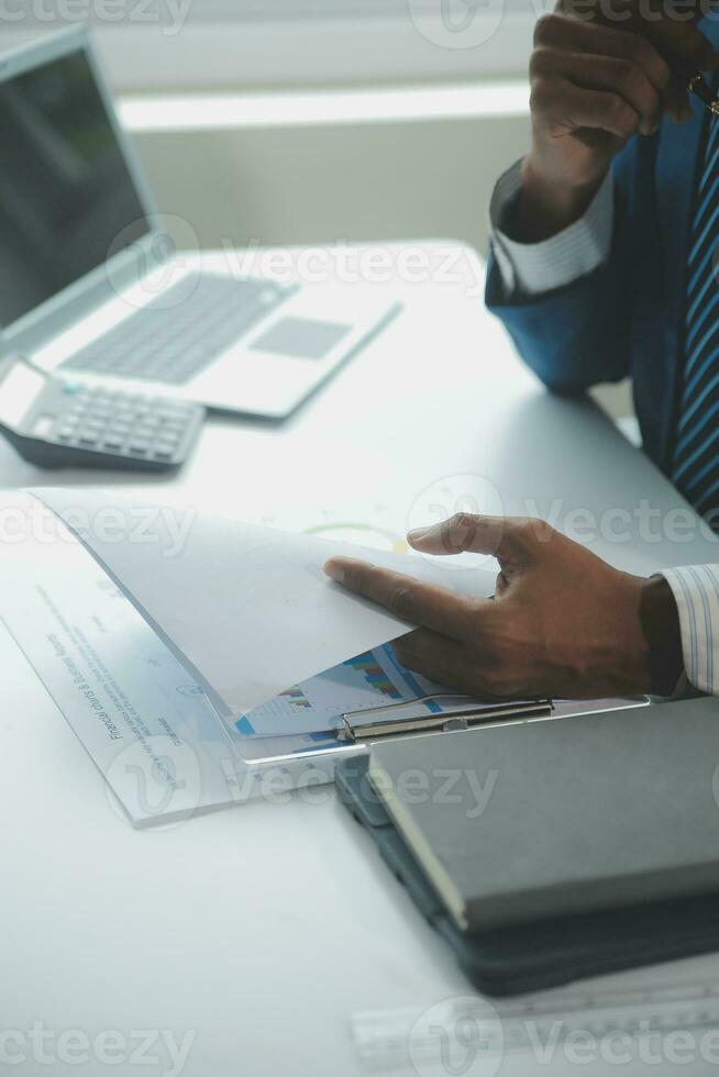 Close up Business woman using calculator and laptop for do math finance on wooden desk, tax, accounting, statistics and analytical research concept photo