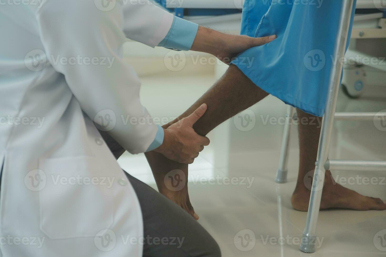 young asian physical therapist working with senior woman on walking with a walker photo