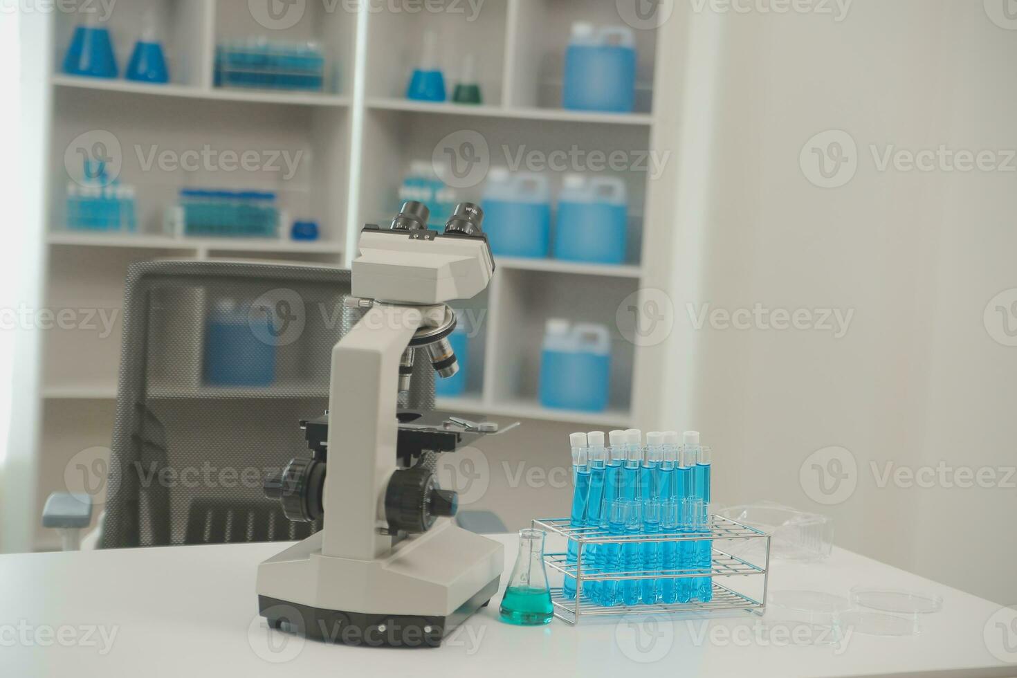 Health care researchers working in life science laboratory. Young female research scientist and senior male supervisor preparing and analyzing microscope slides in research lab. photo