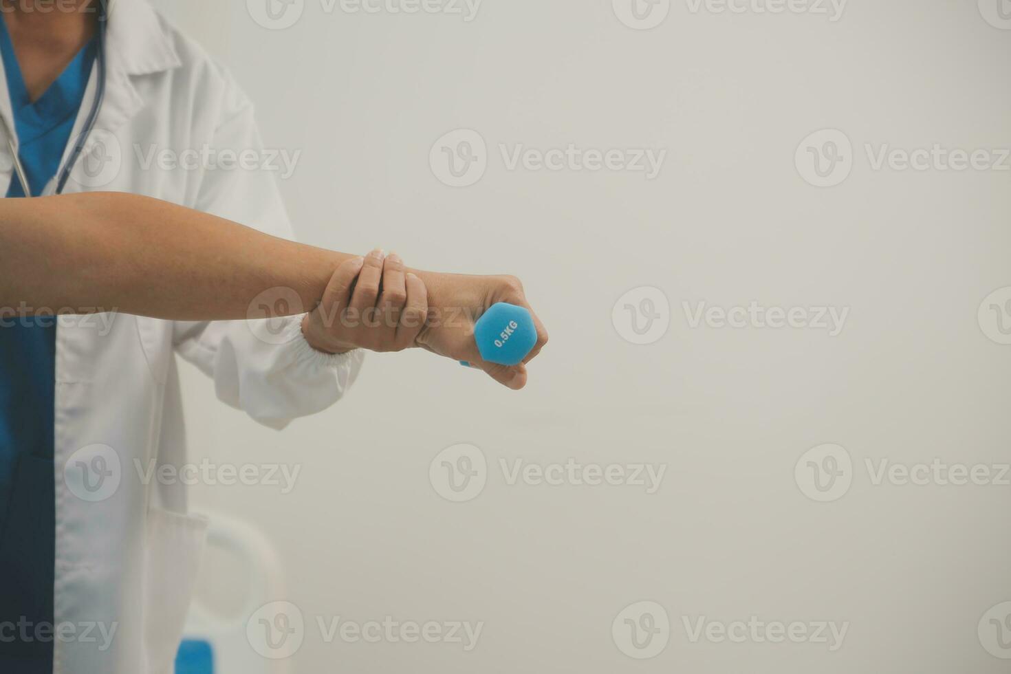 Asian older aged man doing physiotherapist with support from nurse. Senior elderly male sitting on sofa in living room using dumbbells workout exercise for patient with caregiver in nursing care. photo