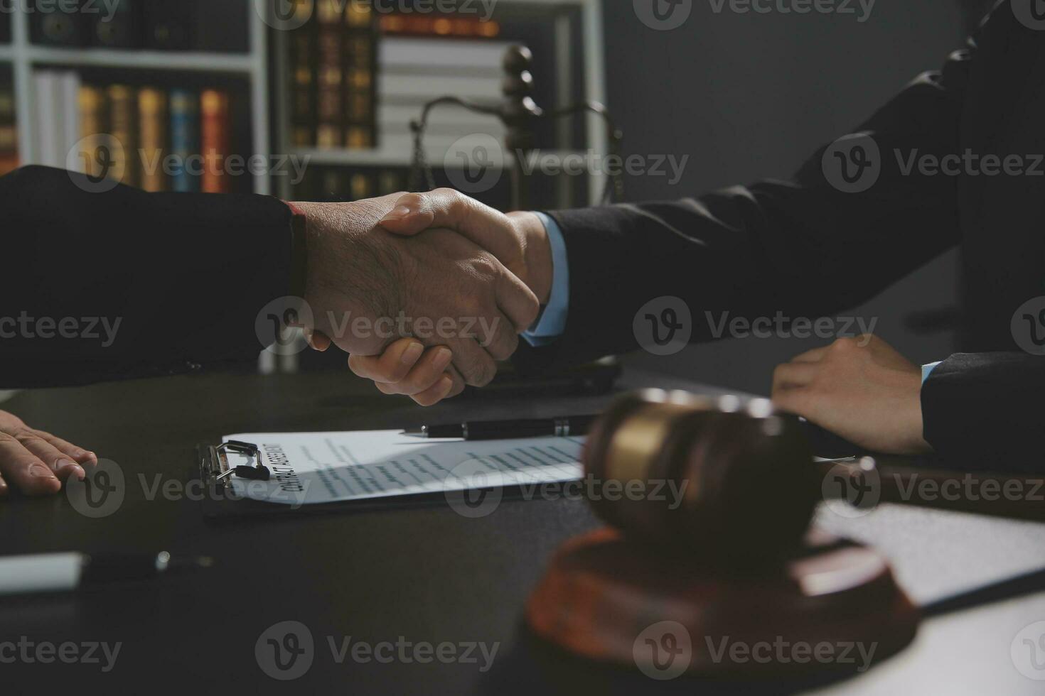 Businessman shaking hands to seal a deal with his partner lawyers or attorneys discussing a contract agreement photo