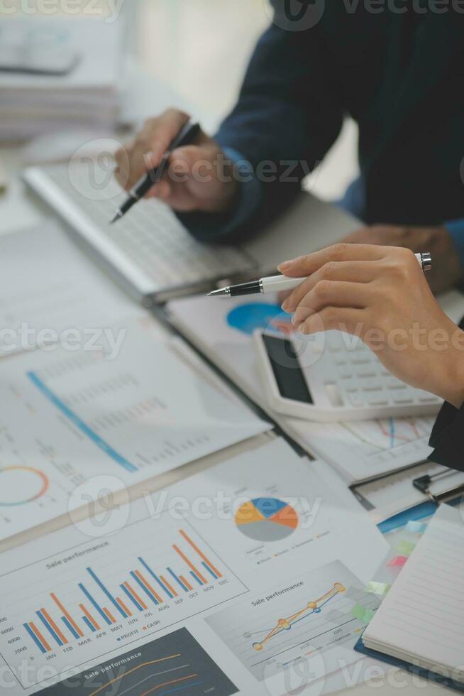 Financial analysts analyze business financial reports on a digital tablet planning investment project during a discussion at a meeting of corporate showing the results of their successful teamwork. photo