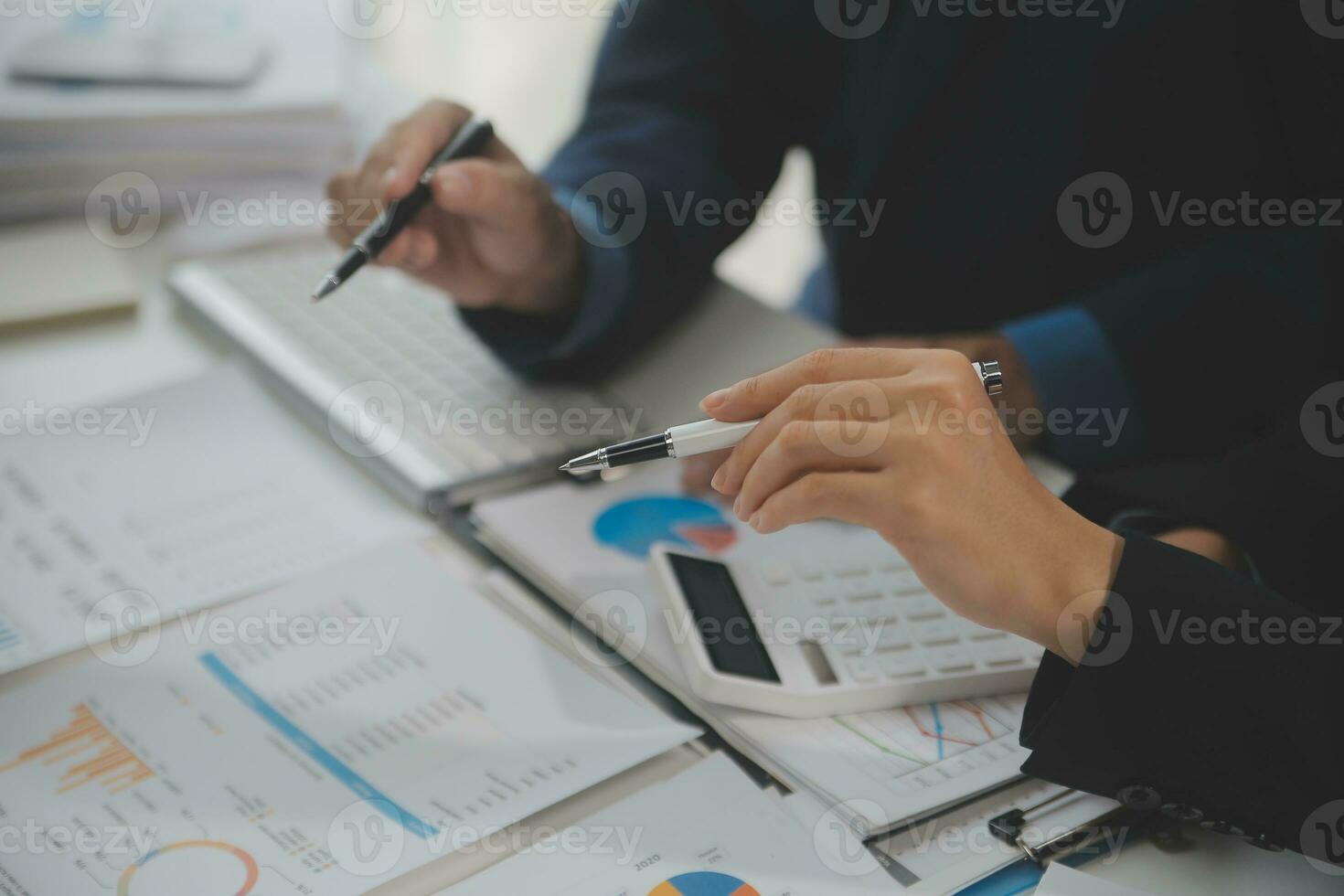 Financial analysts analyze business financial reports on a digital tablet planning investment project during a discussion at a meeting of corporate showing the results of their successful teamwork. photo