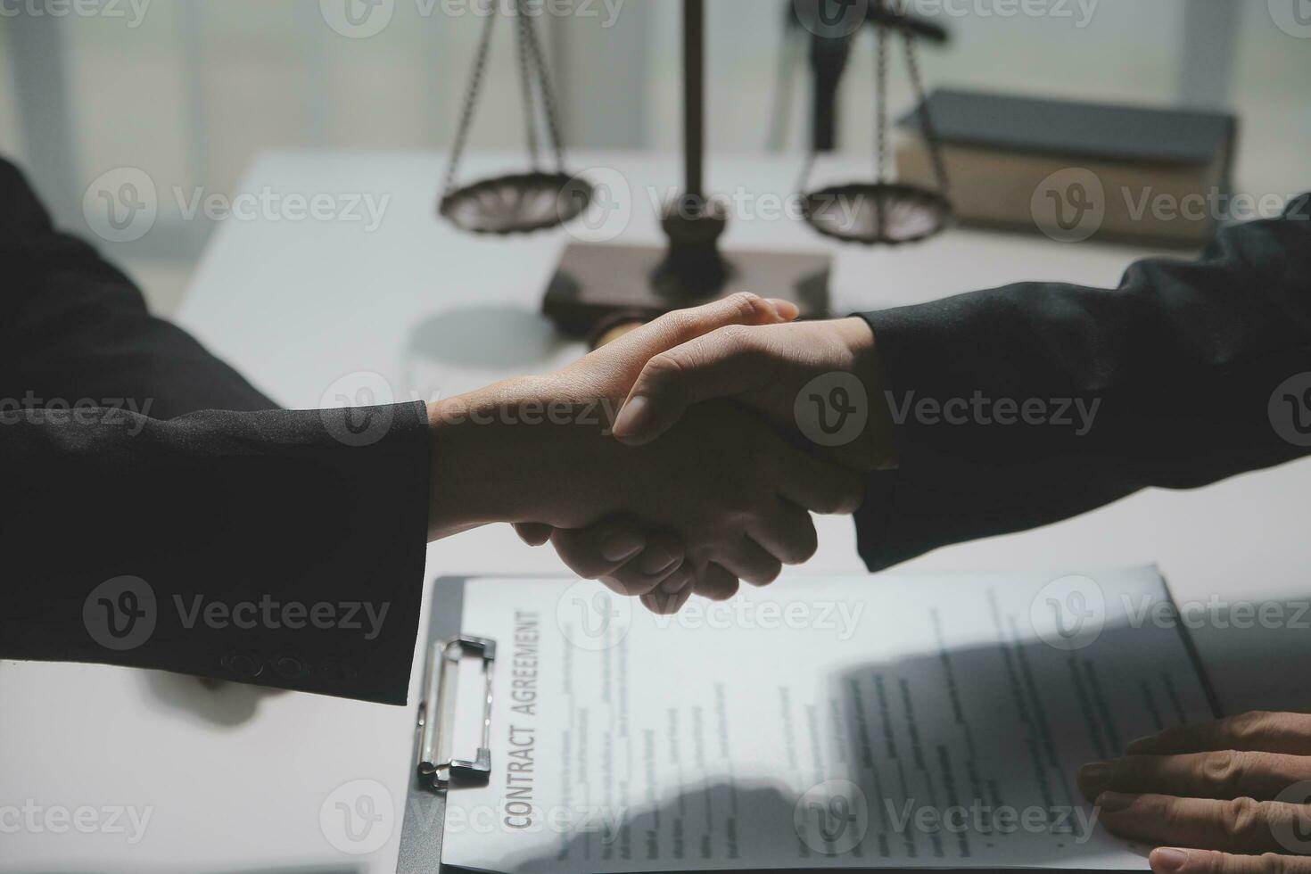 Businessman shaking hands to seal a deal with his partner lawyers or attorneys discussing a contract agreement photo