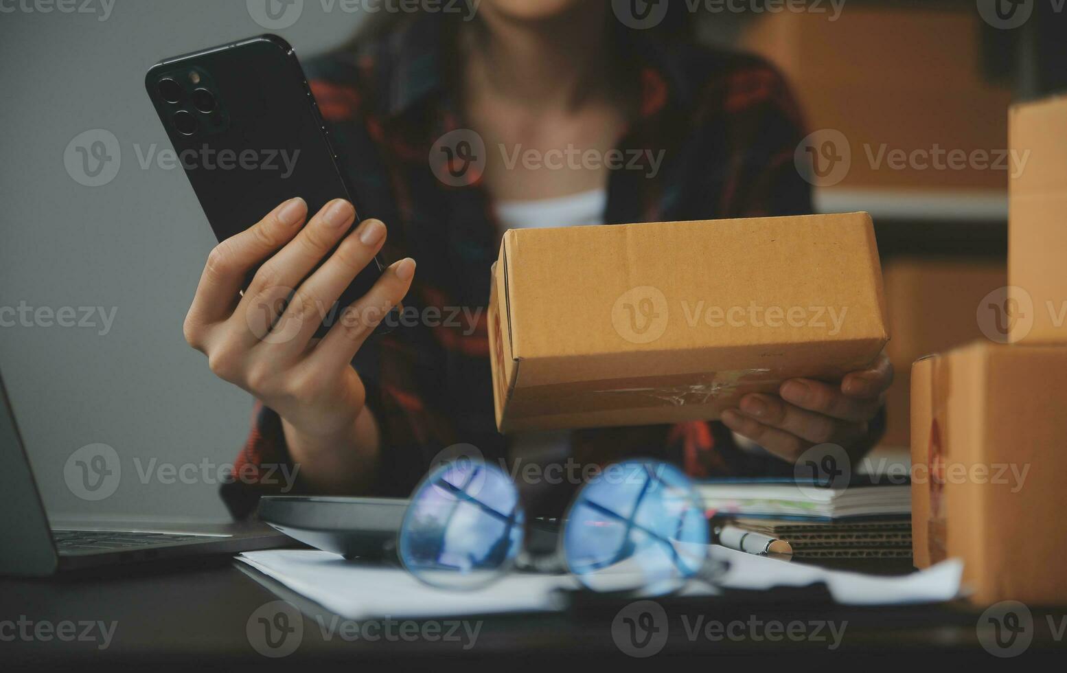 Business woman start up small business entrepreneur SME success .freelance woman working at home with Online Parcel delivery. SME and packaging deliveryconcept photo