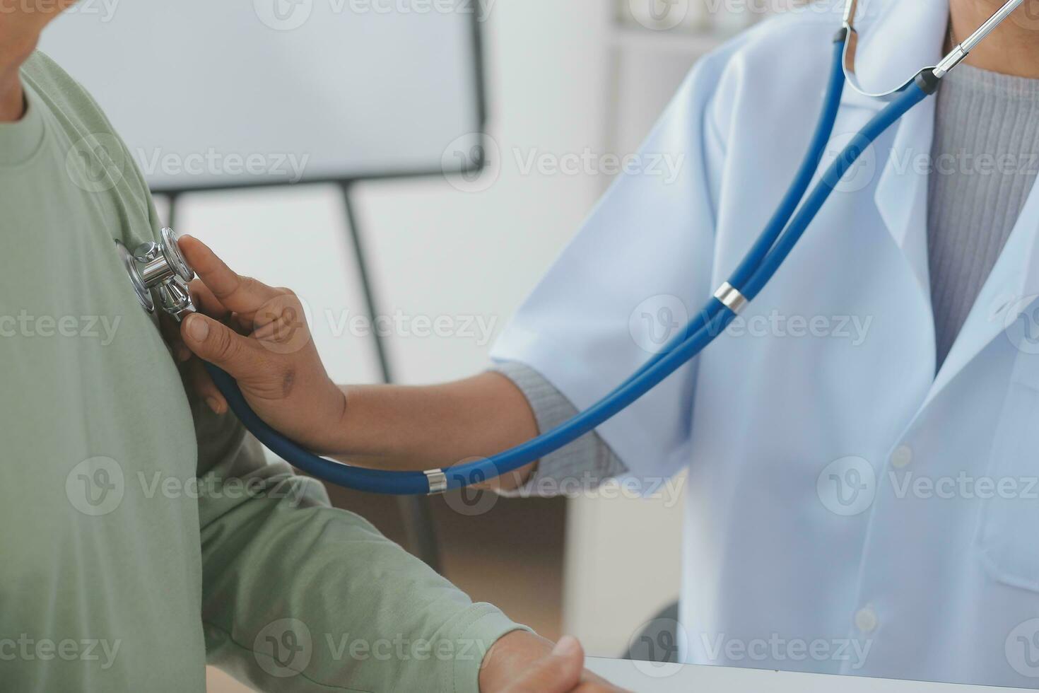 Lets set up an appointment for next week. Cropped shot of a young male doctor going through medical records with his senior male patient. photo