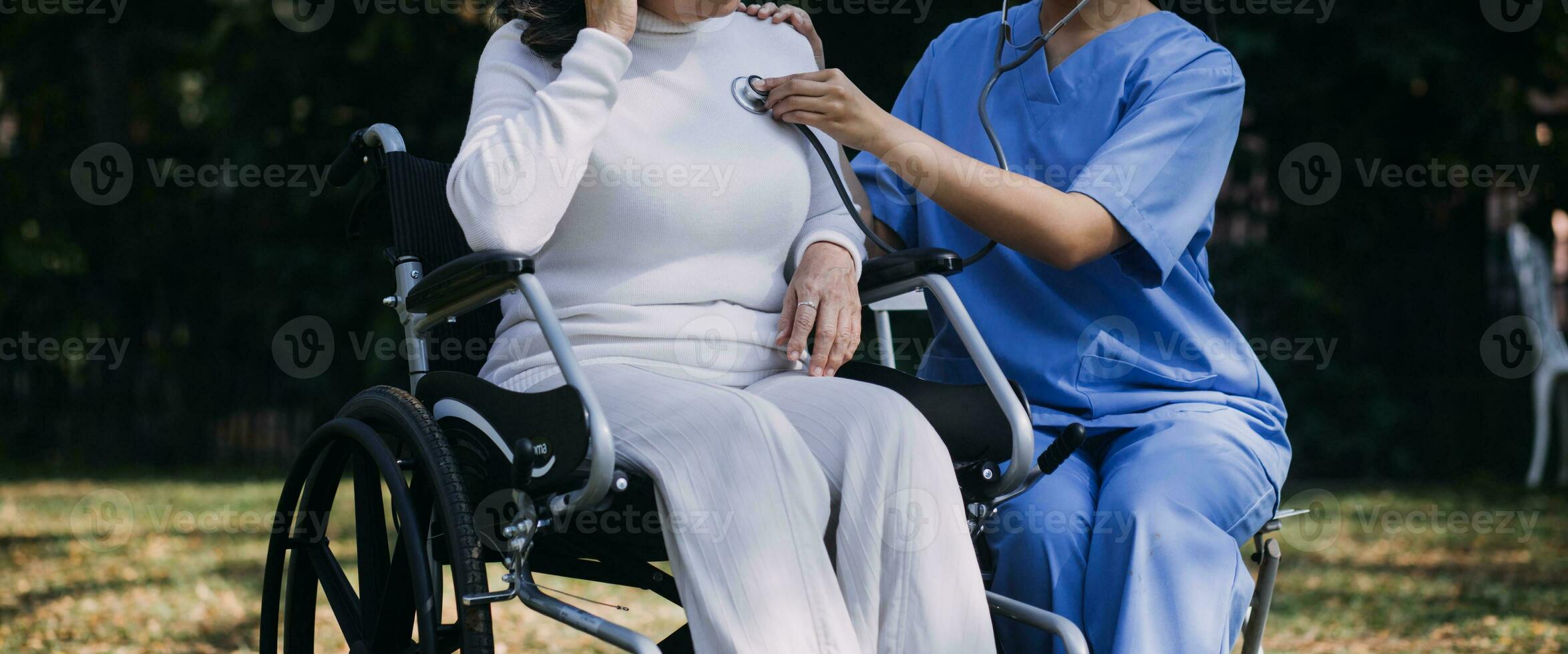 Asian young woman nurse at nursing home take care disabled senior man. Caregiver doctor serve physical therapy for older elderly patient to exercise and practice walking on walker or cane at backyard. photo