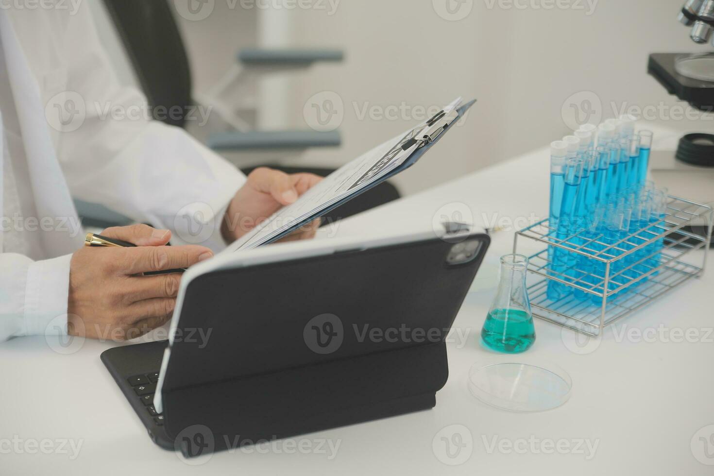 Health care researchers working in life science laboratory. Young female research scientist and senior male supervisor preparing and analyzing microscope slides in research lab. photo