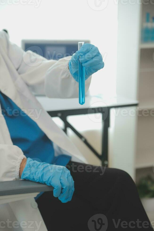 Health care researchers working in life science laboratory. Young female research scientist and senior male supervisor preparing and analyzing microscope slides in research lab. photo