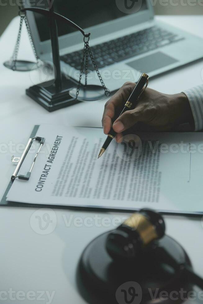 Business and lawyers discussing contract papers with brass scale on desk in office. Law, legal services, advice, justice and law concept picture with film grain effect photo