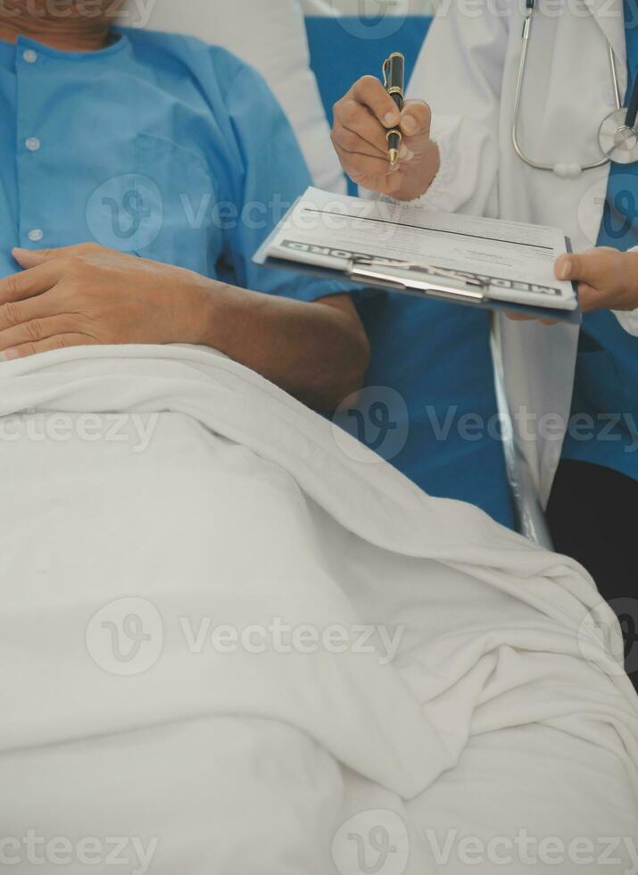 Close up of Female Doctor using stethoscope putting beat heart diagnose with patient in examination room at a hospital, check-up body, Medical and Health Care Concept. photo