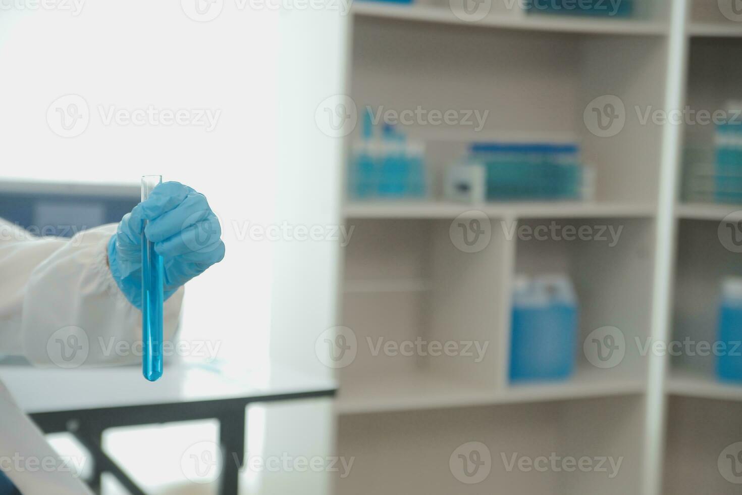 Health care researchers working in life science laboratory. Young female research scientist and senior male supervisor preparing and analyzing microscope slides in research lab. photo