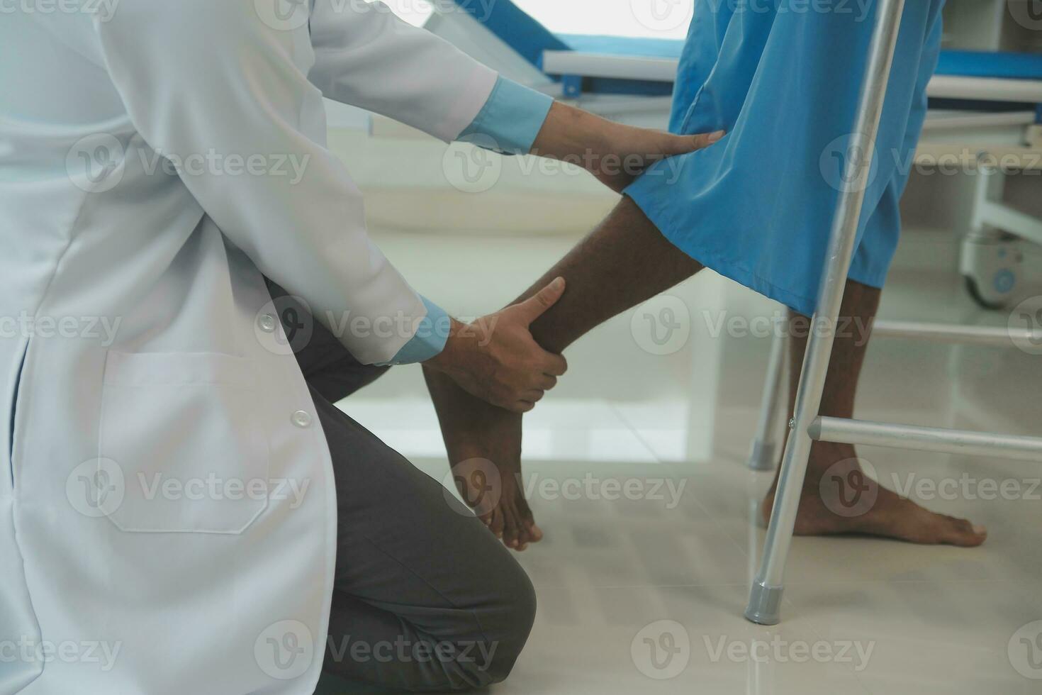 young asian physical therapist working with senior woman on walking with a walker photo