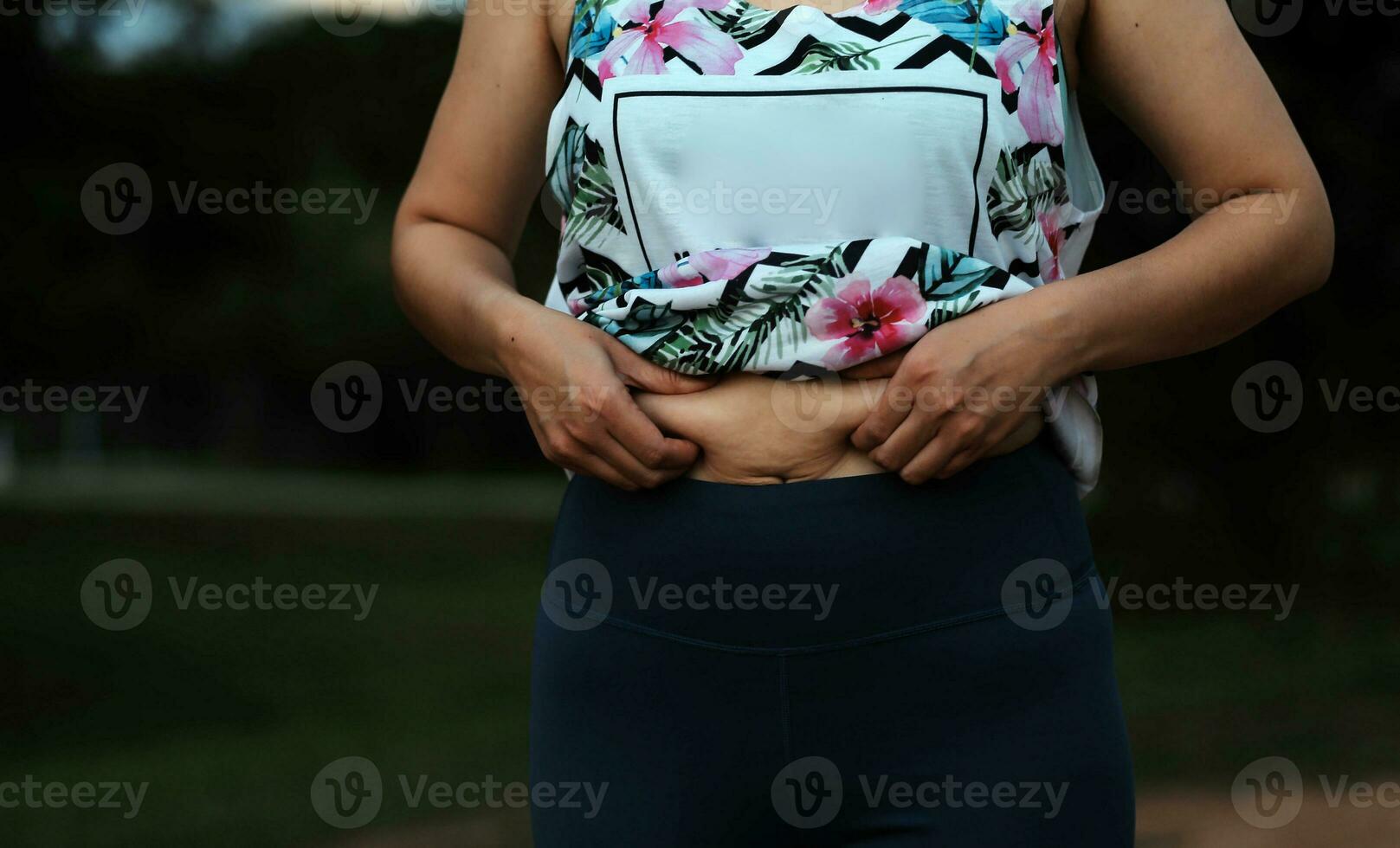 Women body fat belly. Obese woman hand holding excessive belly fat. diet lifestyle concept to reduce belly and shape up healthy stomach muscle. photo