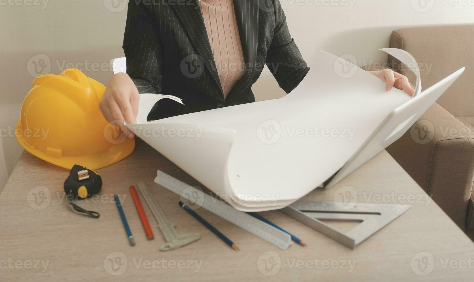 asian woman architect in shirt looking on internet online blueprint document project of green building. female interior designer worker working desktop computer monitor typing keyboard photo