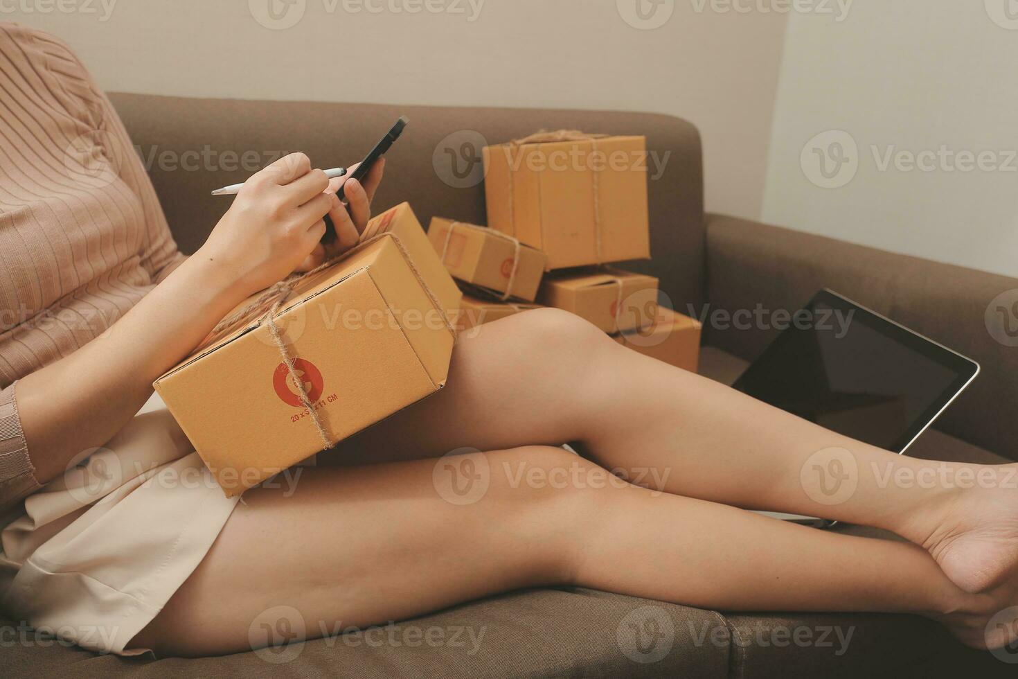 Business woman start up small business entrepreneur SME success .freelance woman working at home with Online Parcel delivery. SME and packaging deliveryconcept photo