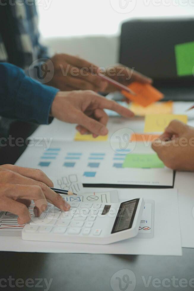 Close up ux developer and ui designer brainstorming about mobile app interface wireframe design on table with customer breif and color code at modern office.Creative digital development agency photo