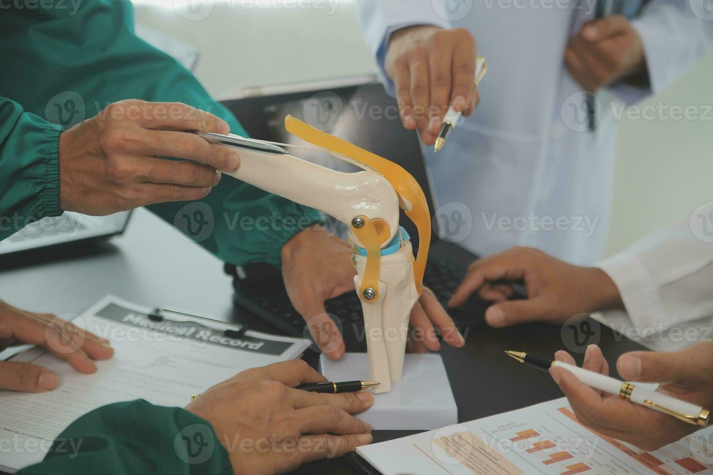 Group of doctors reading a document in meeting room at hospital photo