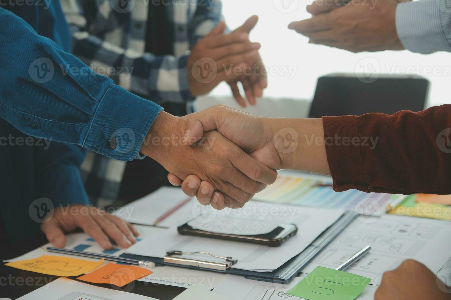 Close up ux developer and ui designer brainstorming about mobile app interface wireframe design on table with customer breif and color code at modern office.Creative digital development agency photo