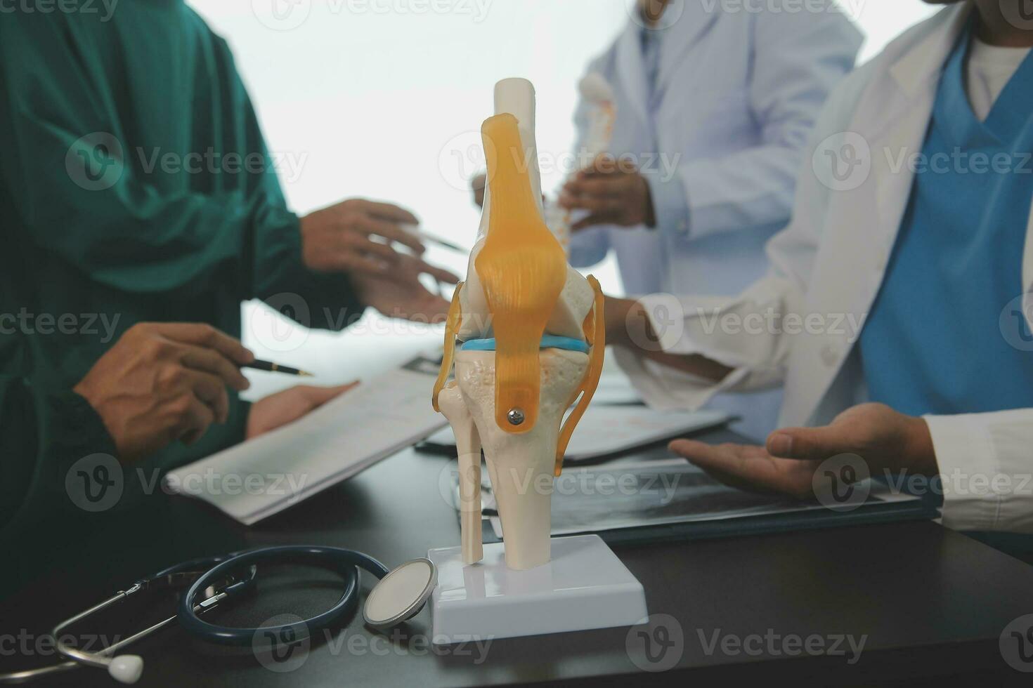 Group of doctors reading a document in meeting room at hospital photo