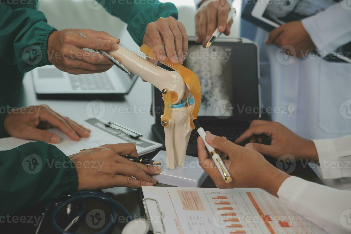 Group of doctors reading a document in meeting room at hospital photo