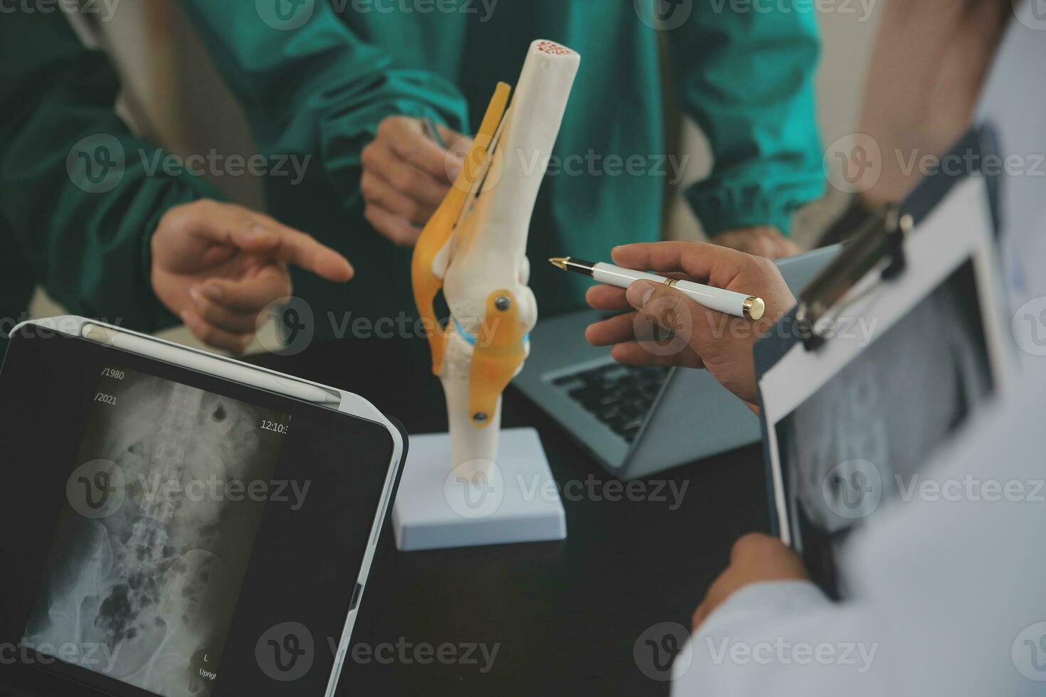 Group of doctors reading a document in meeting room at hospital photo