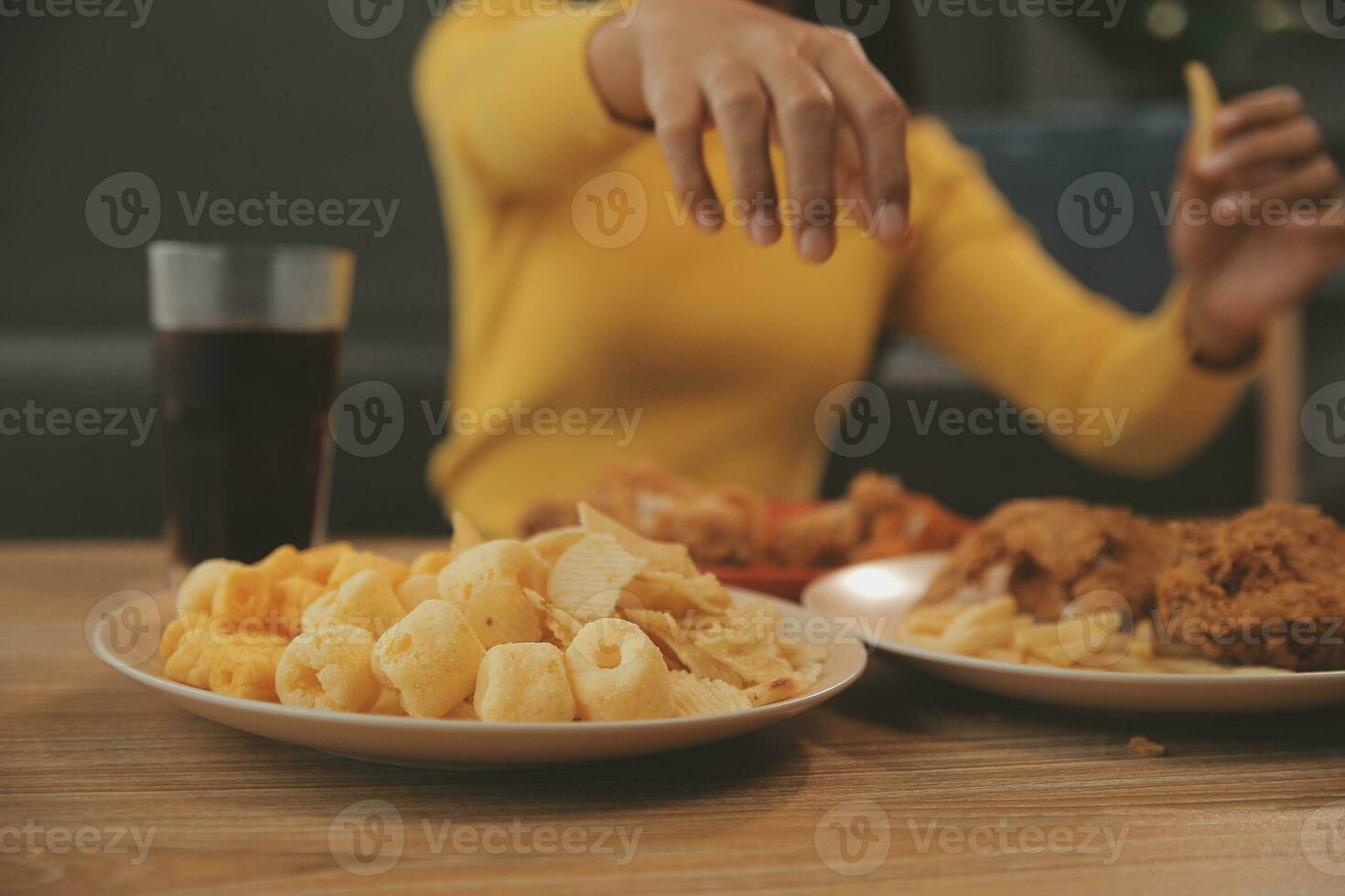 fat woman bite piece of pizza,overweight female is eating fast foods,asian girl is hungry photo