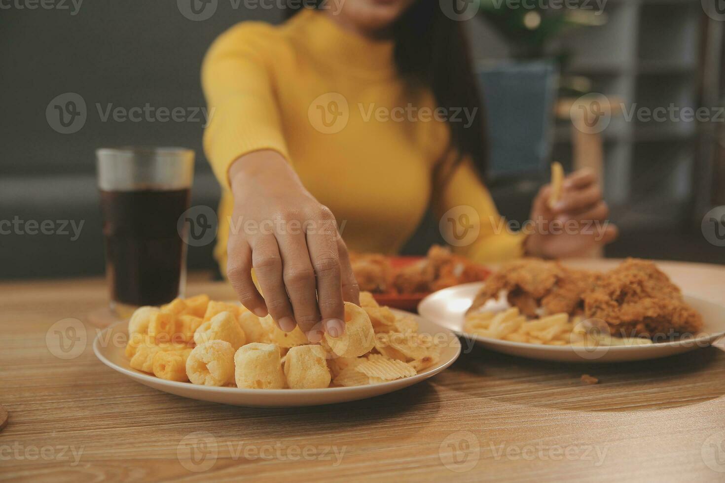 fat woman bite piece of pizza,overweight female is eating fast foods,asian girl is hungry photo