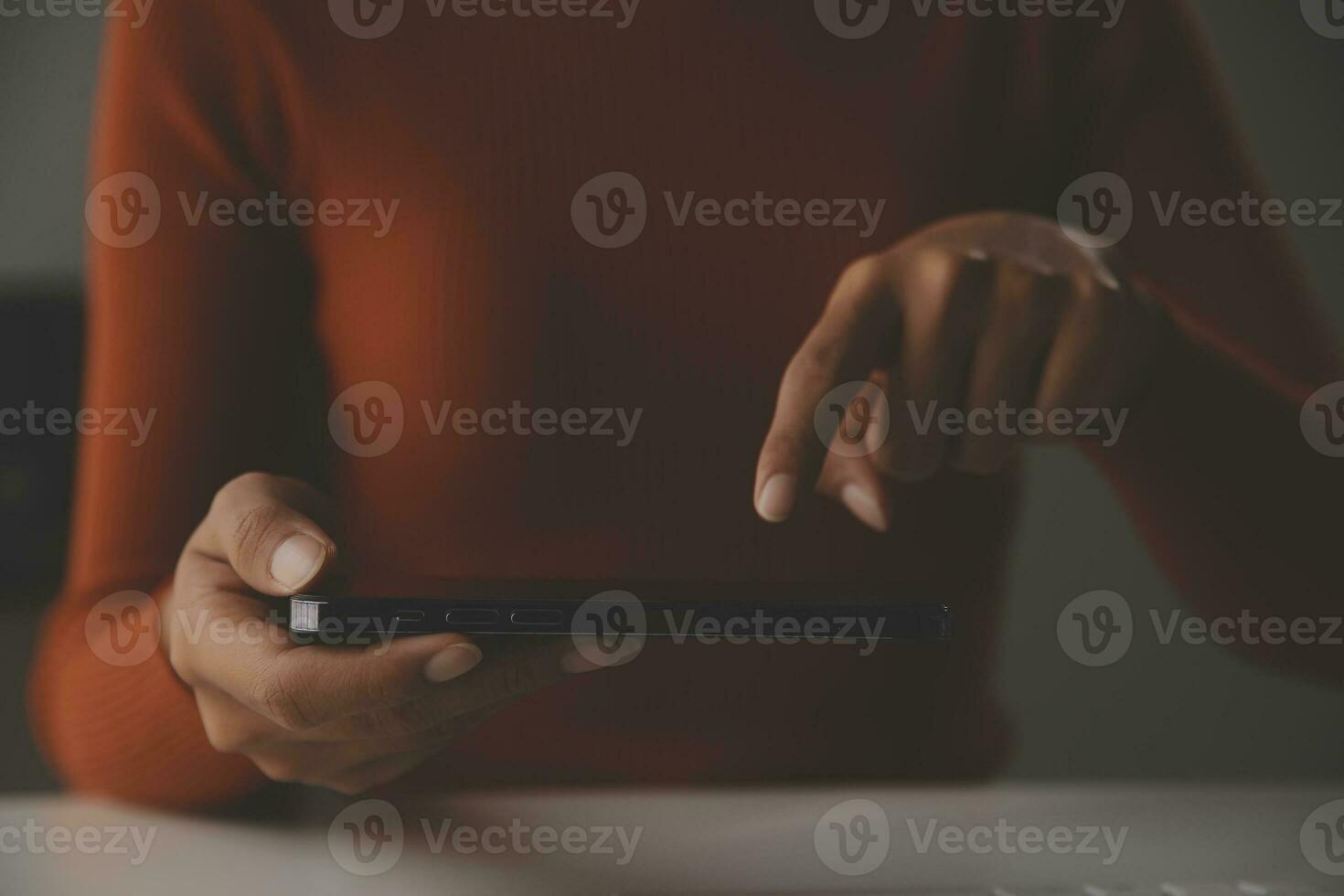 Asian Businesswoman Using laptop computer and working at office with calculator document on desk, doing planning analyzing the financial report, business plan investment, finance analysis concept. photo