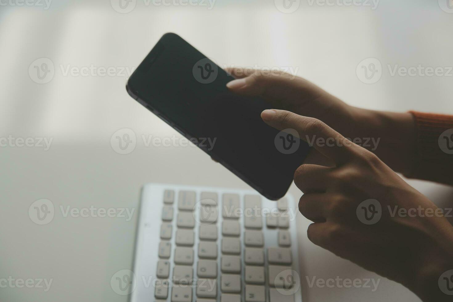 Asian Businesswoman Using laptop computer and working at office with calculator document on desk, doing planning analyzing the financial report, business plan investment, finance analysis concept. photo