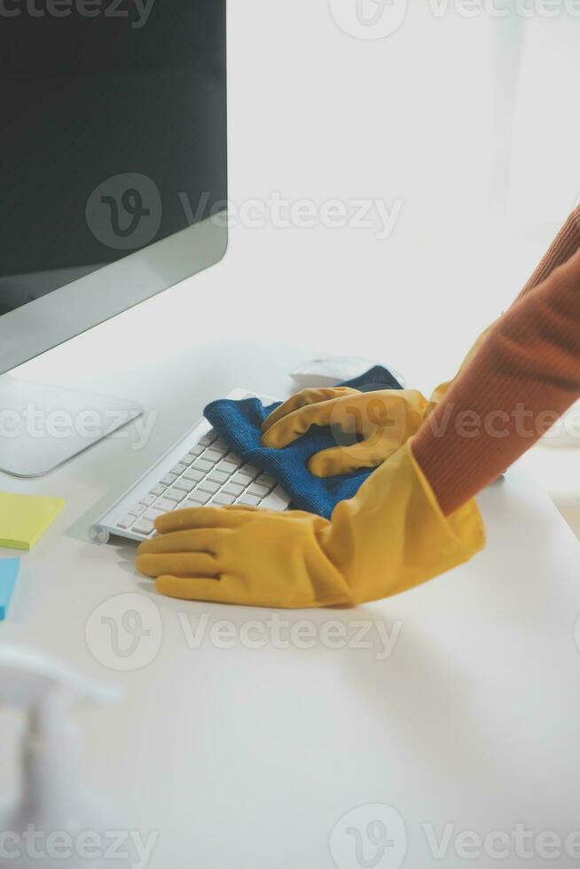 Office Cleaning Service. Janitor Spraying Desk. Workplace Hygiene photo
