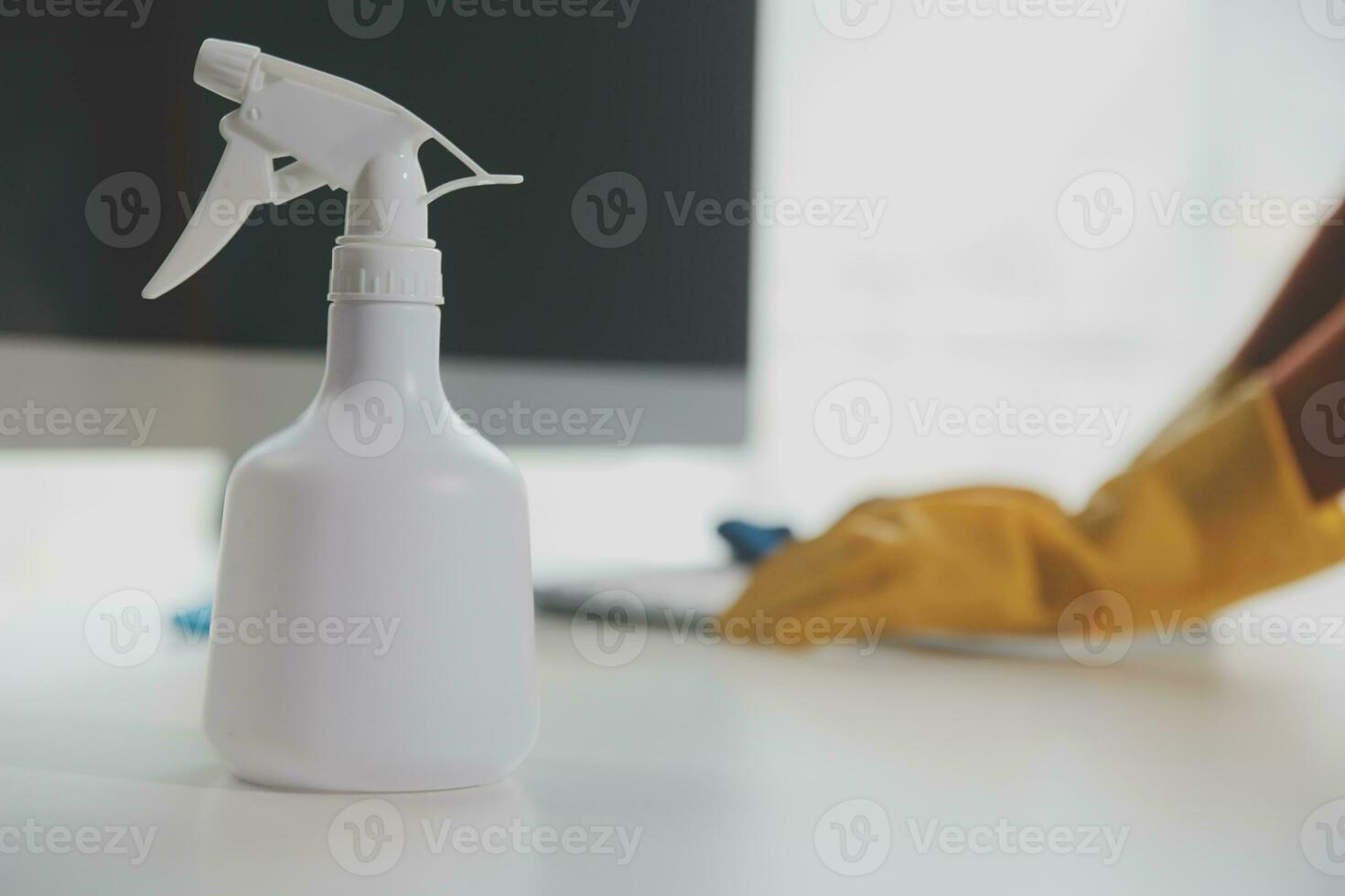 Office Cleaning Service. Janitor Spraying Desk. Workplace Hygiene photo