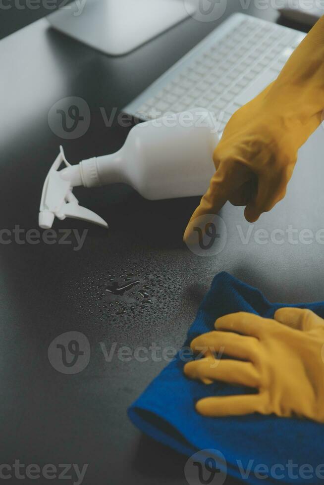 Office Cleaning Service. Janitor Spraying Desk. Workplace Hygiene photo
