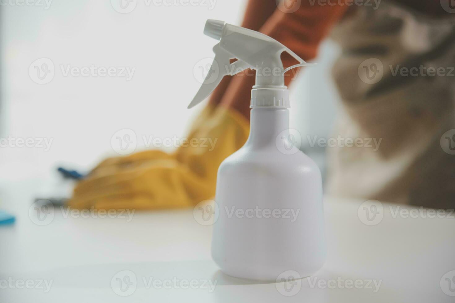 Office Cleaning Service. Janitor Spraying Desk. Workplace Hygiene photo