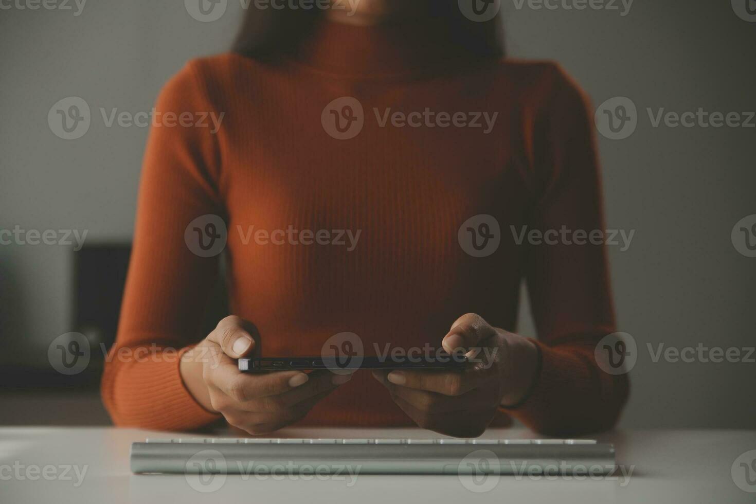 Asian Businesswoman Using laptop computer and working at office with calculator document on desk, doing planning analyzing the financial report, business plan investment, finance analysis concept. photo