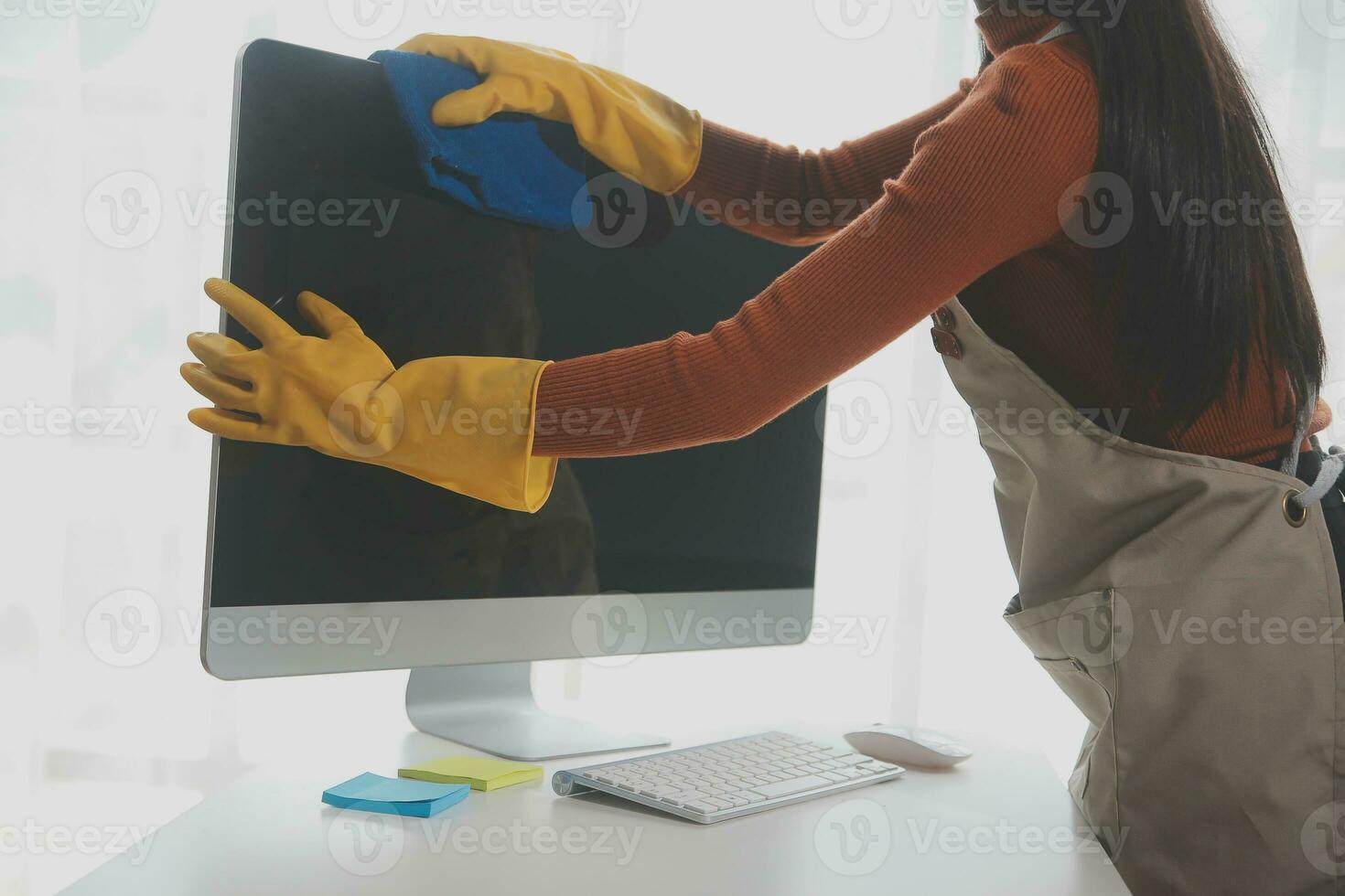 Office Cleaning Service. Janitor Spraying Desk. Workplace Hygiene photo