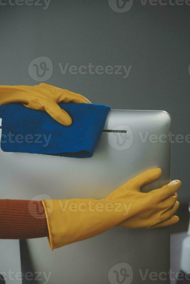 Office Cleaning Service. Janitor Spraying Desk. Workplace Hygiene photo