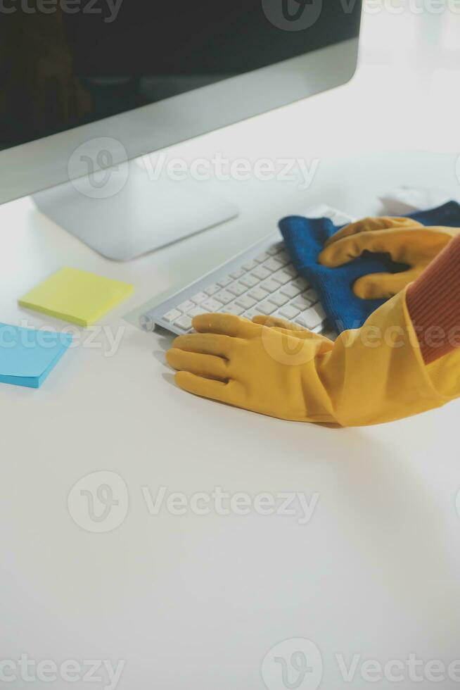 Office Cleaning Service. Janitor Spraying Desk. Workplace Hygiene photo