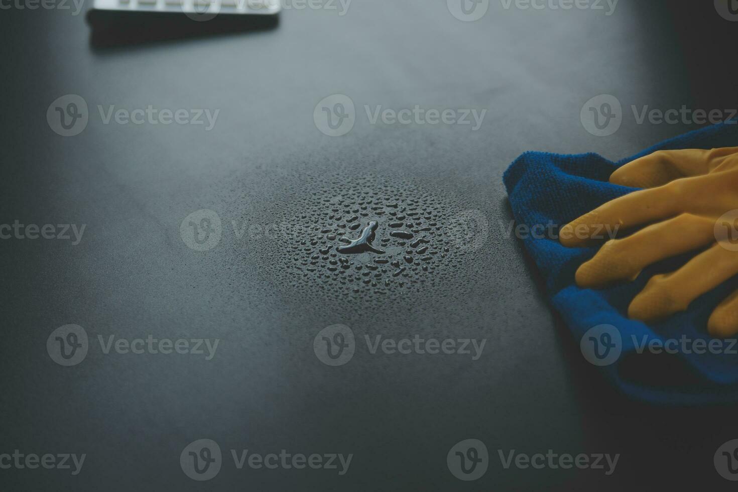Office Cleaning Service. Janitor Spraying Desk. Workplace Hygiene photo