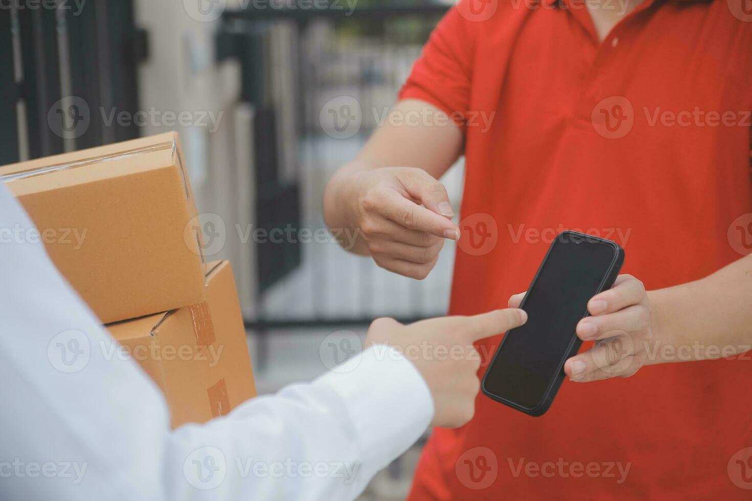 Asian Woman Receiving Product from delivery man at Home, Young Owner Woman Order Product from Smartphone Application, Woman with Online Business or SME Concept. photo