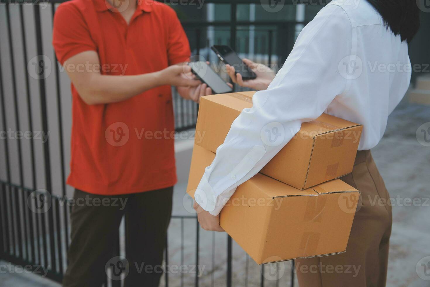 Asian Woman Receiving Product from delivery man at Home, Young Owner Woman Order Product from Smartphone Application, Woman with Online Business or SME Concept. photo