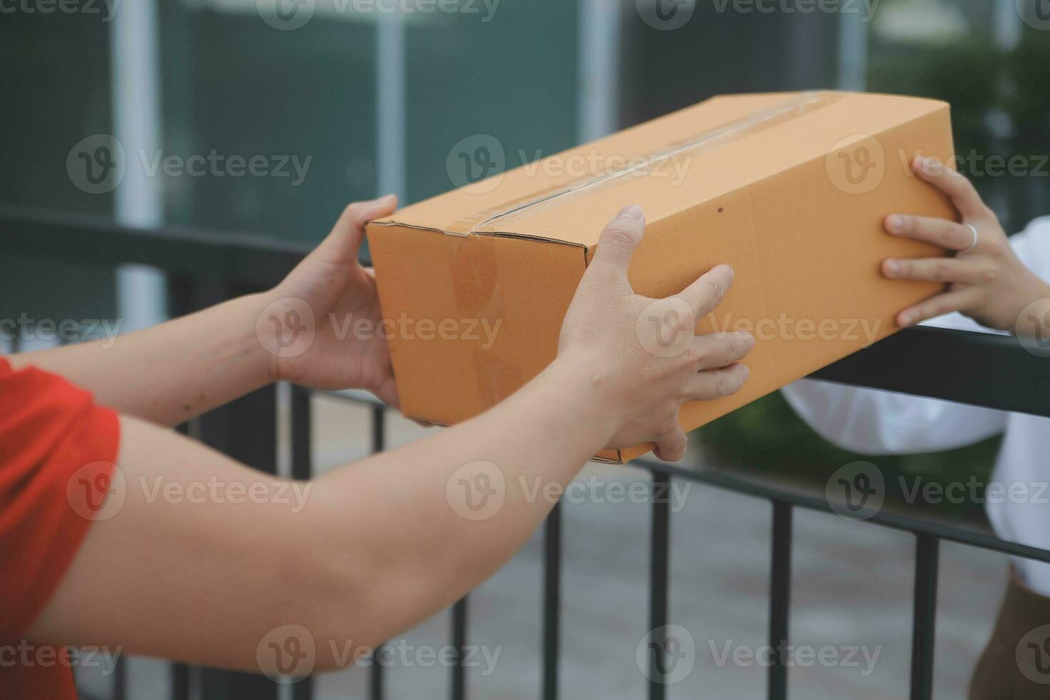 Asian Woman Receiving Product from delivery man at Home, Young Owner Woman Order Product from Smartphone Application, Woman with Online Business or SME Concept. photo