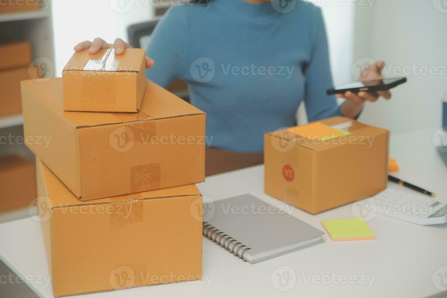 Business woman start up small business entrepreneur SME success .freelance woman working at home with Online Parcel delivery. SME and packaging deliveryconcept photo