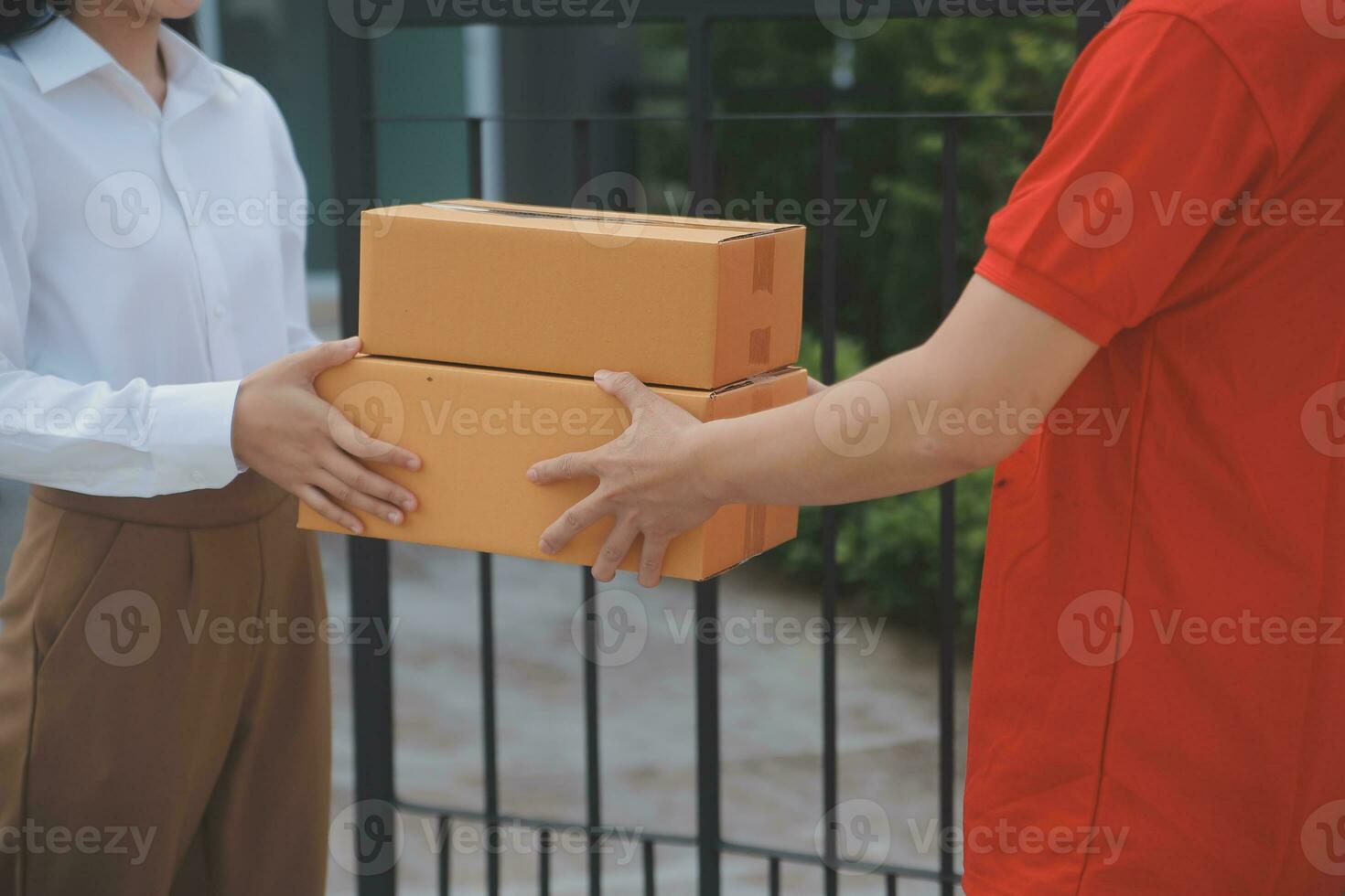 Asian Woman Receiving Product from delivery man at Home, Young Owner Woman Order Product from Smartphone Application, Woman with Online Business or SME Concept. photo