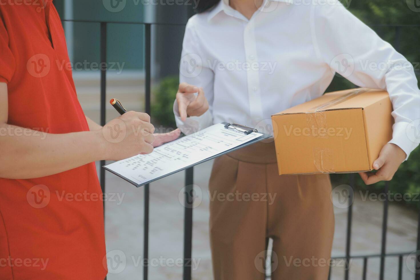 Asian Woman Receiving Product from delivery man at Home, Young Owner Woman Order Product from Smartphone Application, Woman with Online Business or SME Concept. photo