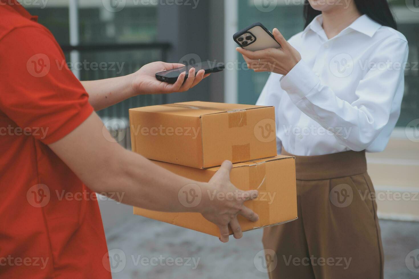 Asian Woman Receiving Product from delivery man at Home, Young Owner Woman Order Product from Smartphone Application, Woman with Online Business or SME Concept. photo
