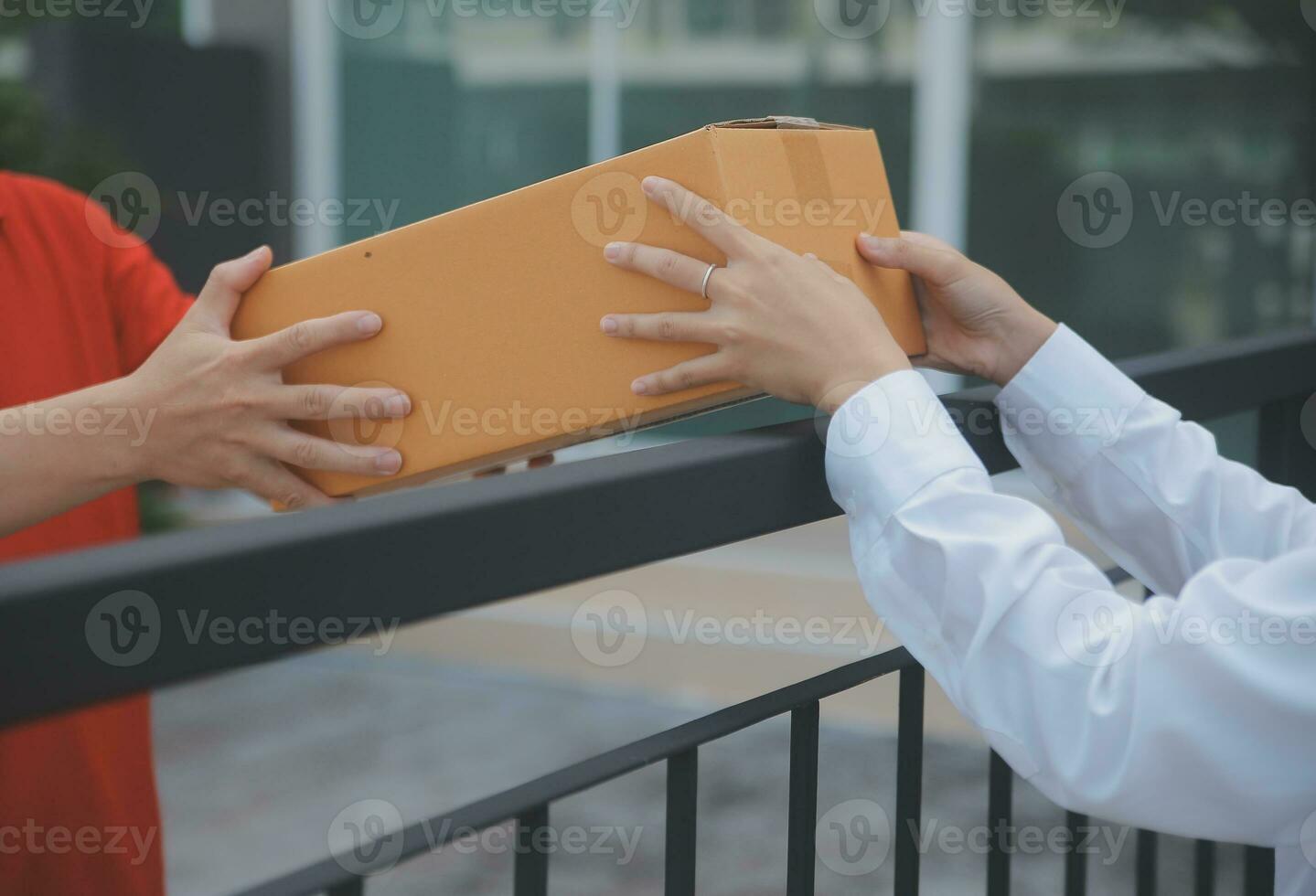 Asian Woman Receiving Product from delivery man at Home, Young Owner Woman Order Product from Smartphone Application, Woman with Online Business or SME Concept. photo