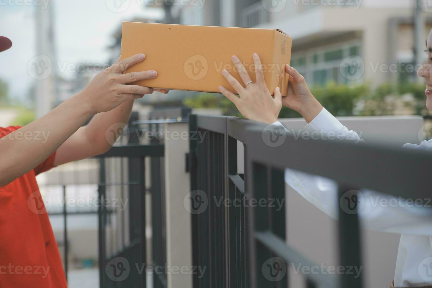 Asian Woman Receiving Product from delivery man at Home, Young Owner Woman Order Product from Smartphone Application, Woman with Online Business or SME Concept. photo